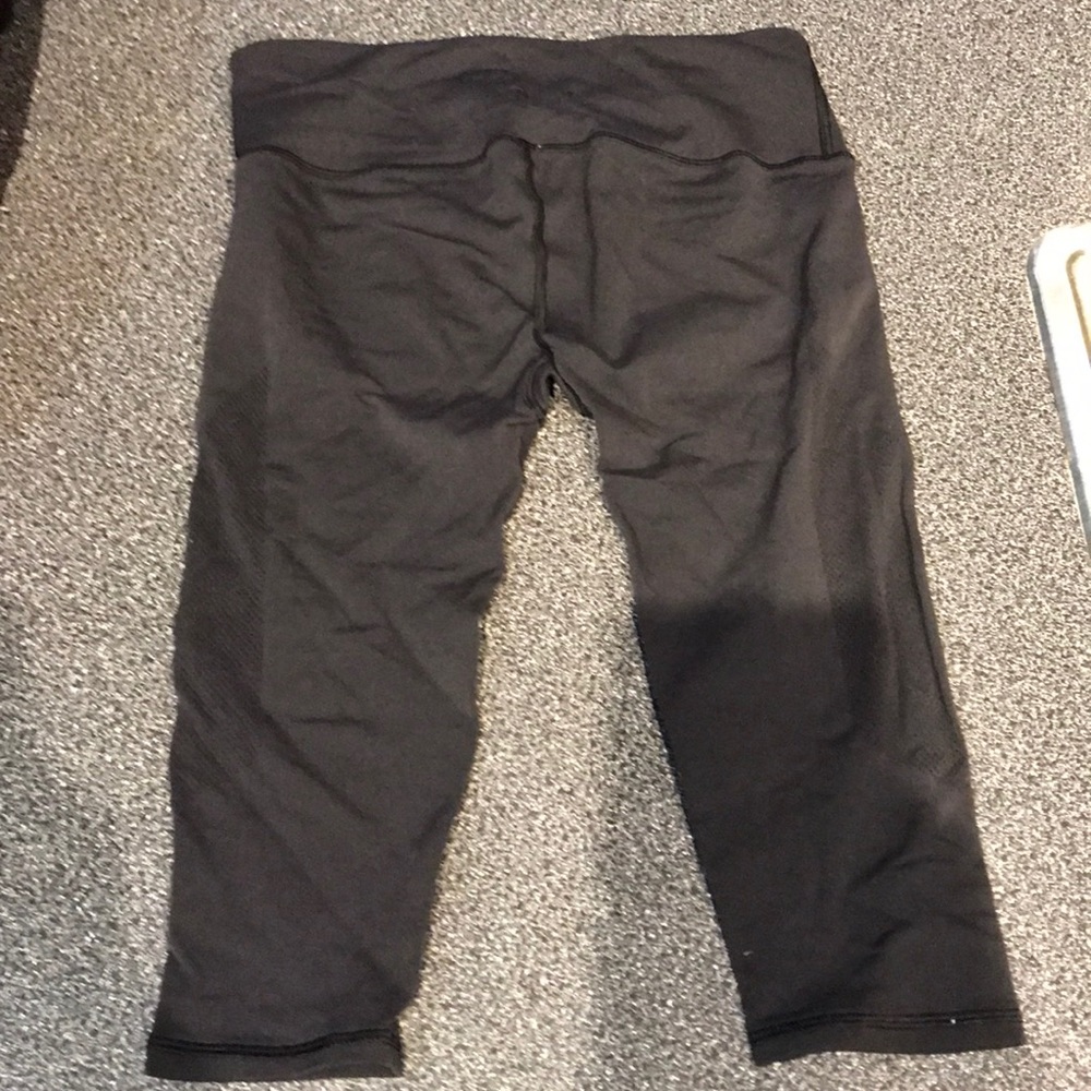 Black Lululemon leggings with mesh sides.